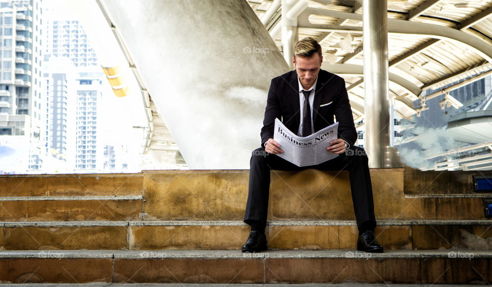 businessman reading newspaper
