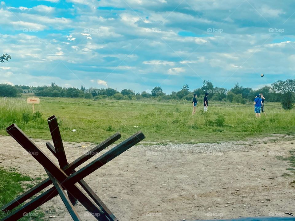 Boys playing football near minefield