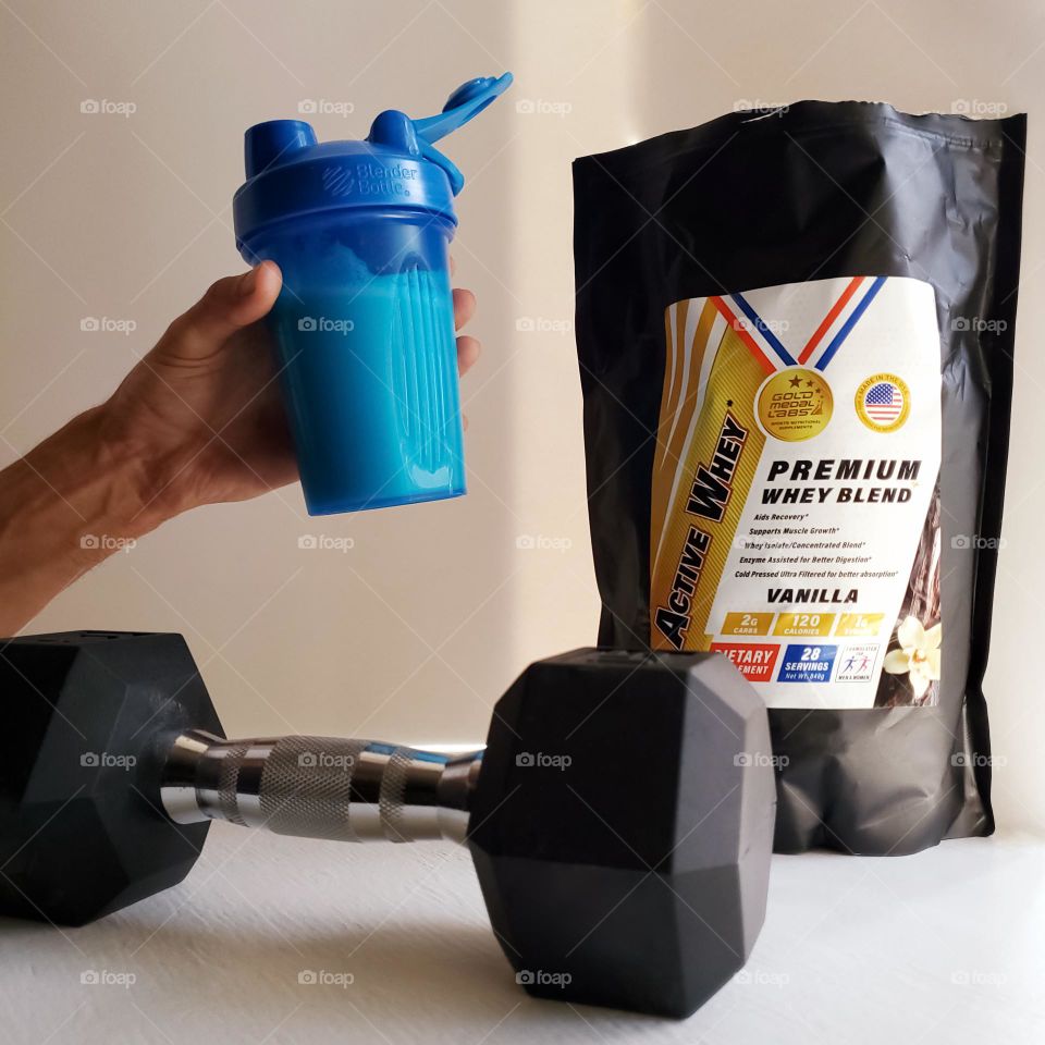 Resolutions: Nutrition and fitness with whey protein shakes and weight lifting dumbells.