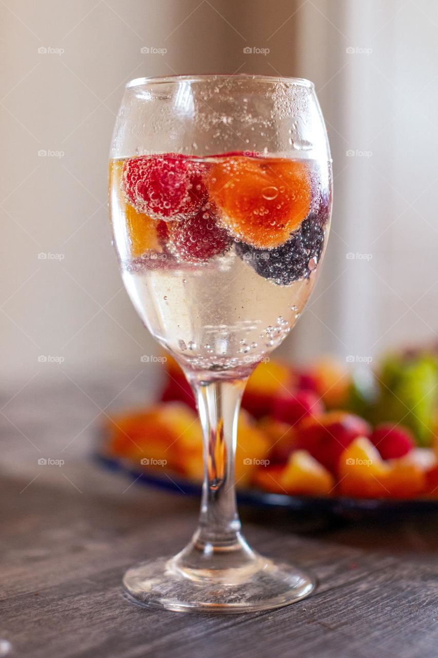 Fruits and the glass of aqua mineral water