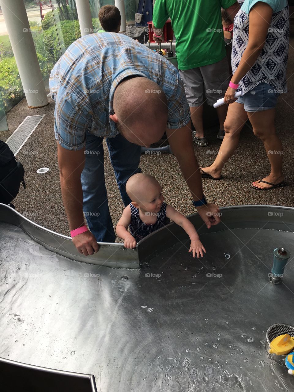 Dad and son playing in water at kids museum