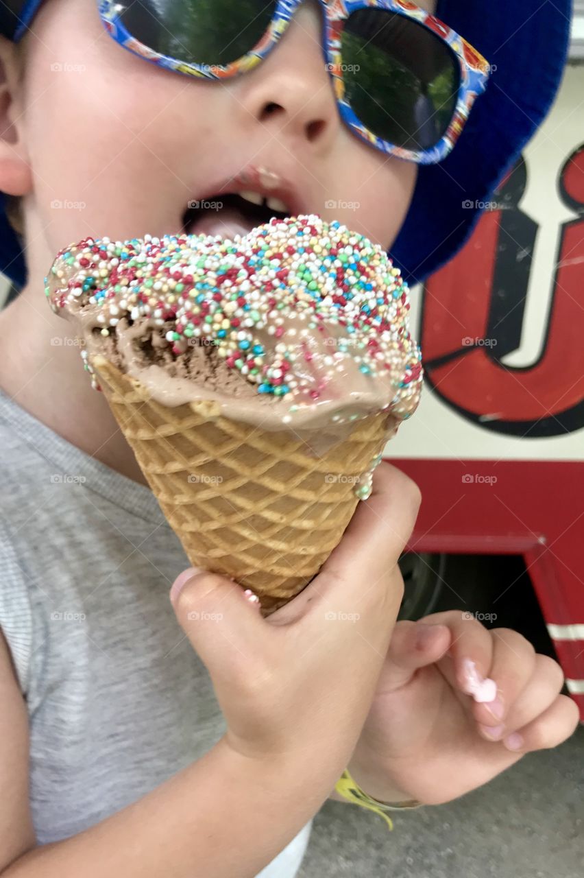 Little boy eats ice cream on a summer day