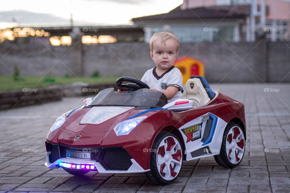 Little boy driving toy car