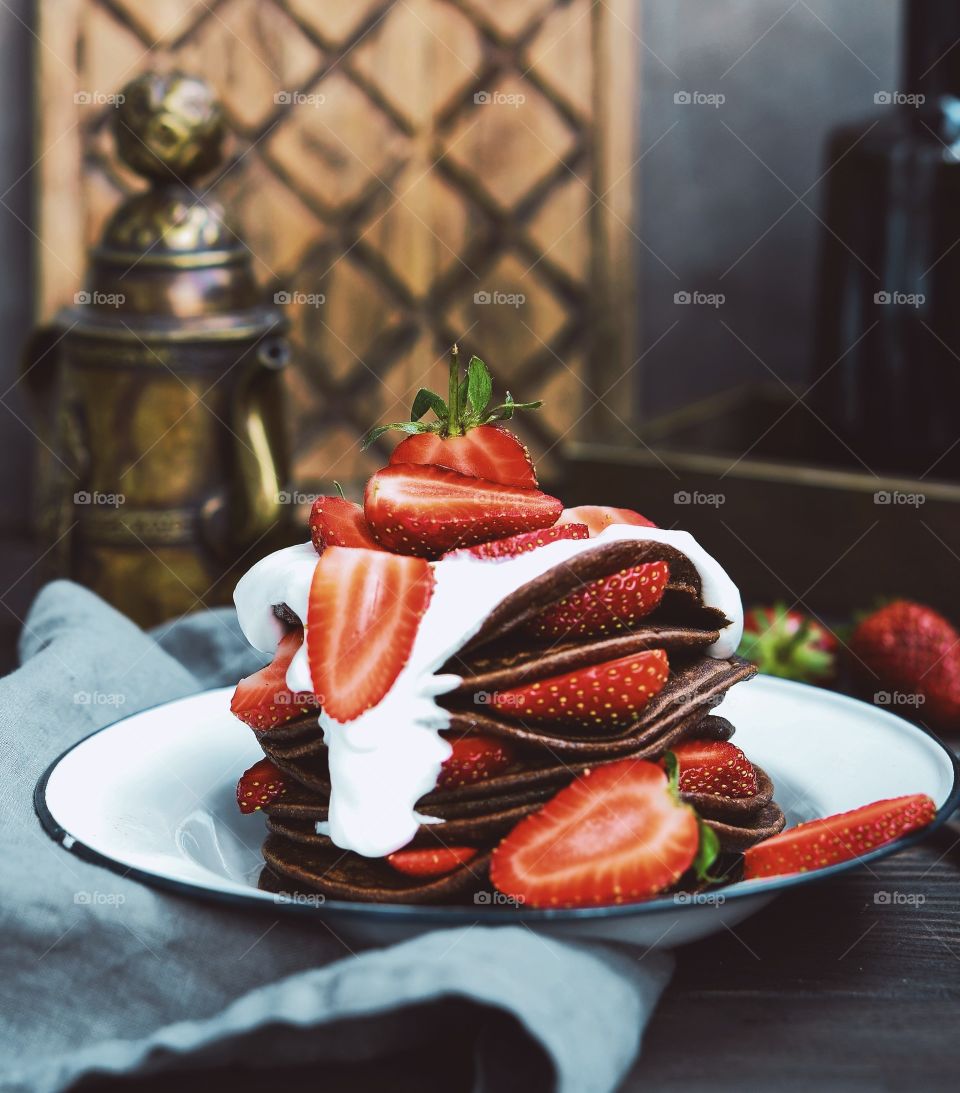 chocolate pancakes with strawberry and cream