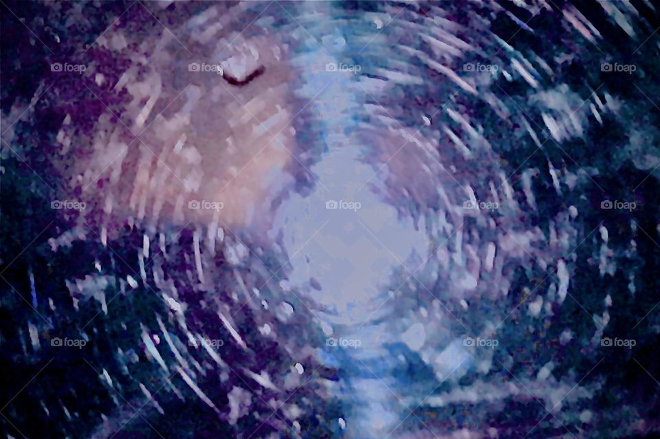 A ornamented piece of glass with multiple circular etchings give the impression of a „swirl in space-time“ à la „Albert Einstein“ with rainbow color refractions. 2020. Hypnotic Productions