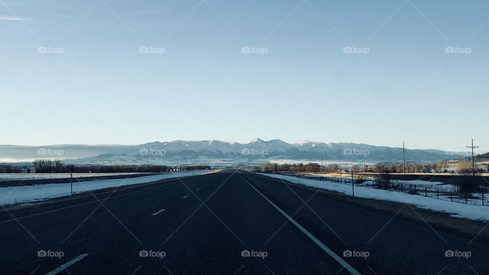 Open road to snowy mountains 