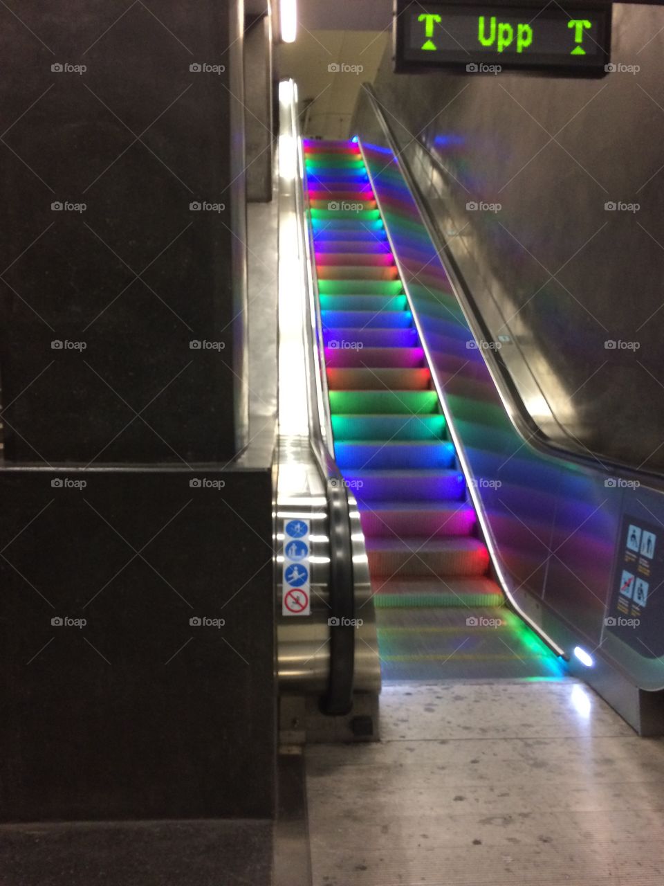 Escalator with rainbow lights. 