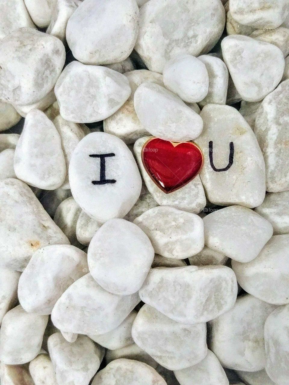 Text and heart shape on white stone