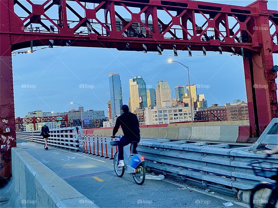 This is the bicycle lane of the „Pulaski Bridge” at “Newtown Creek” seen from the pedestrian lane crossing over to LIC, Queens from “Greenpoint”, Brooklyn on a beautiful warm sunny Indian summer evening in early October 2023. Hypnotic Productions