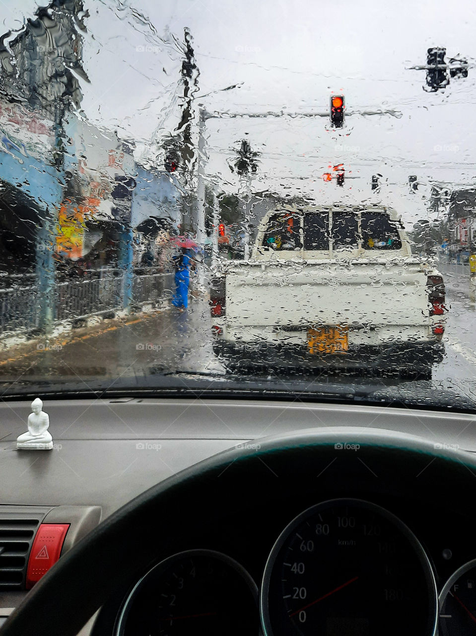 On the way to the workplace on a wet morning. Waiting for traffic lights. Rainy days. Eastern monsoon time in the northern part of Sri Lanka.