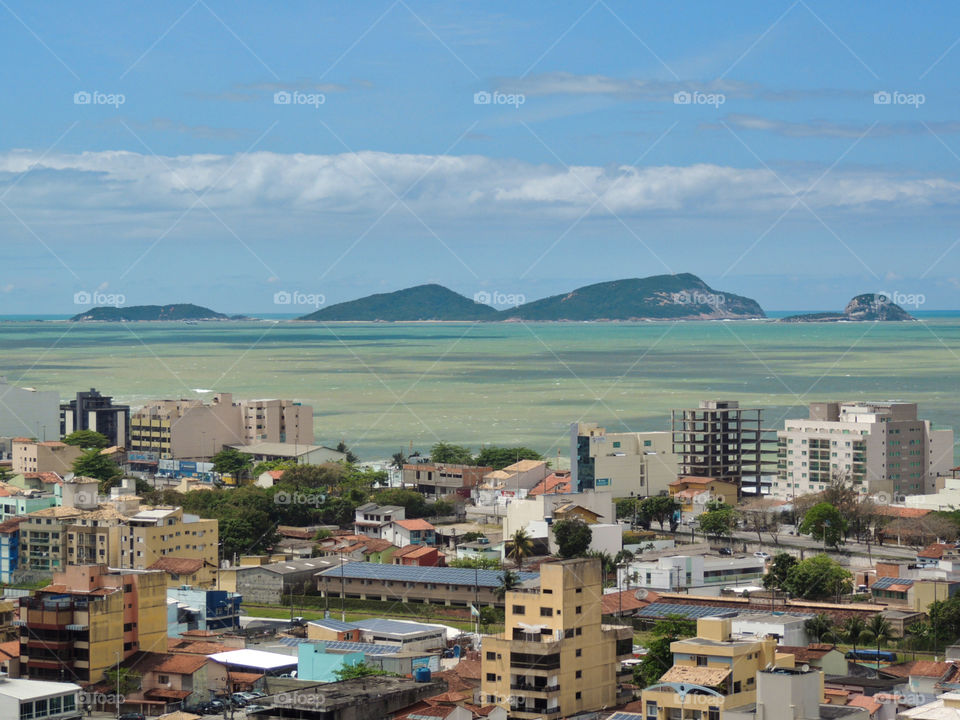 City View where the Urban mixes with nature. It’s possible to see buildings, houses, constructions and at the same time in the background we can see the sea, the islands with a sunny sky