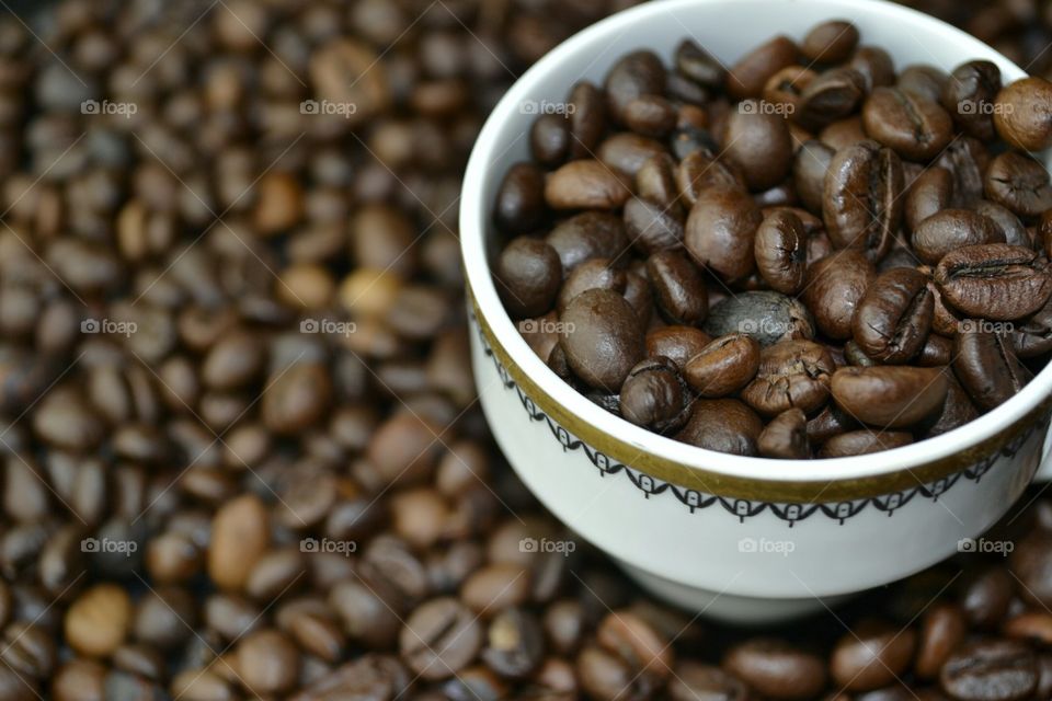 Roasted coffee beans in cup