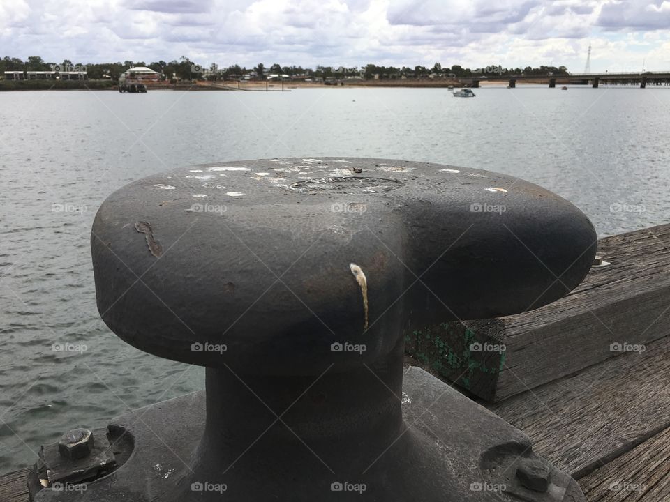 Giant iron cleat at ship dock wharf, 