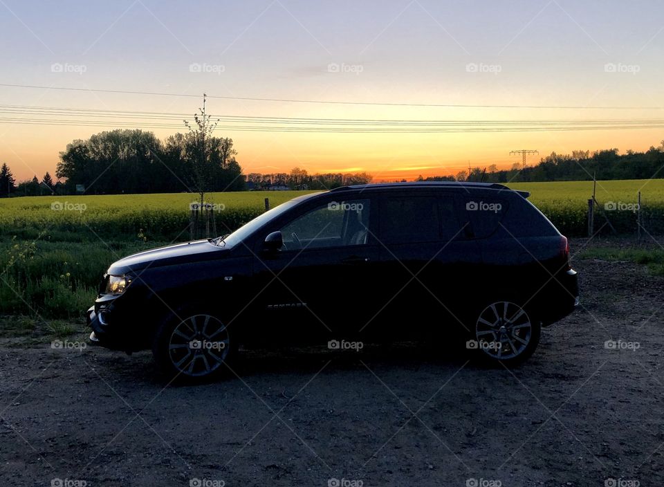 sunset with my car in the field