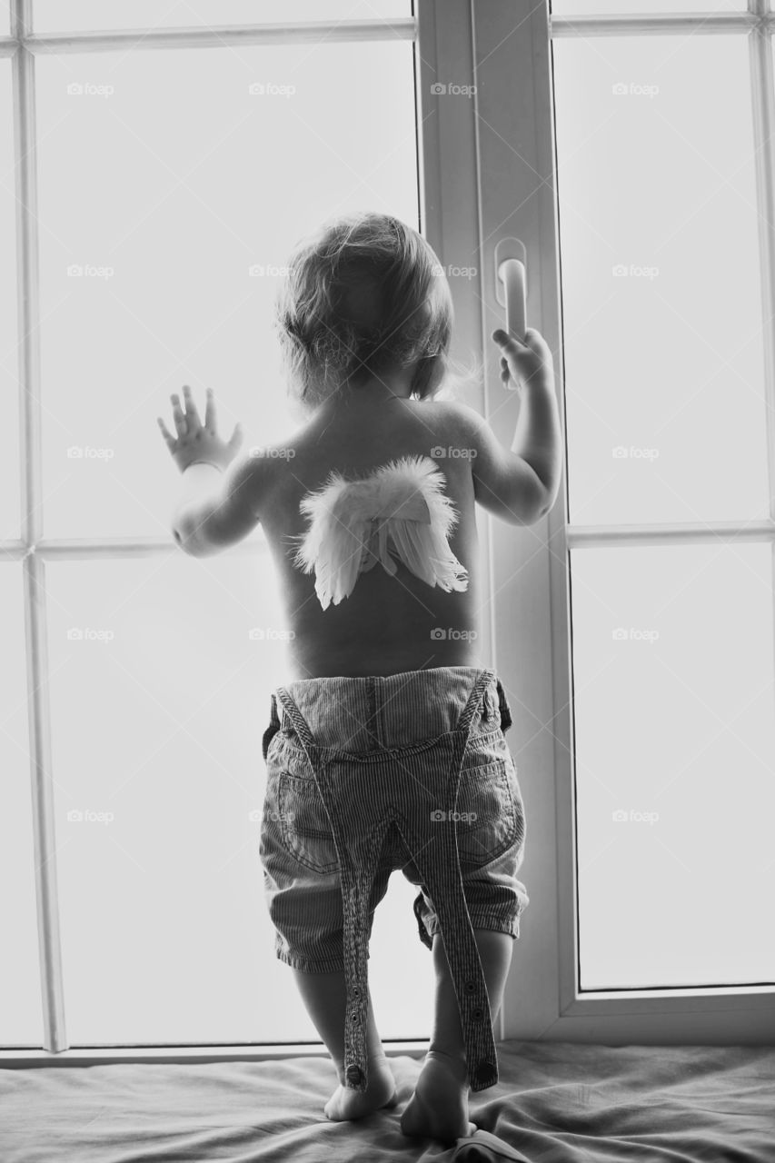 Rear view of girl standing in front of door