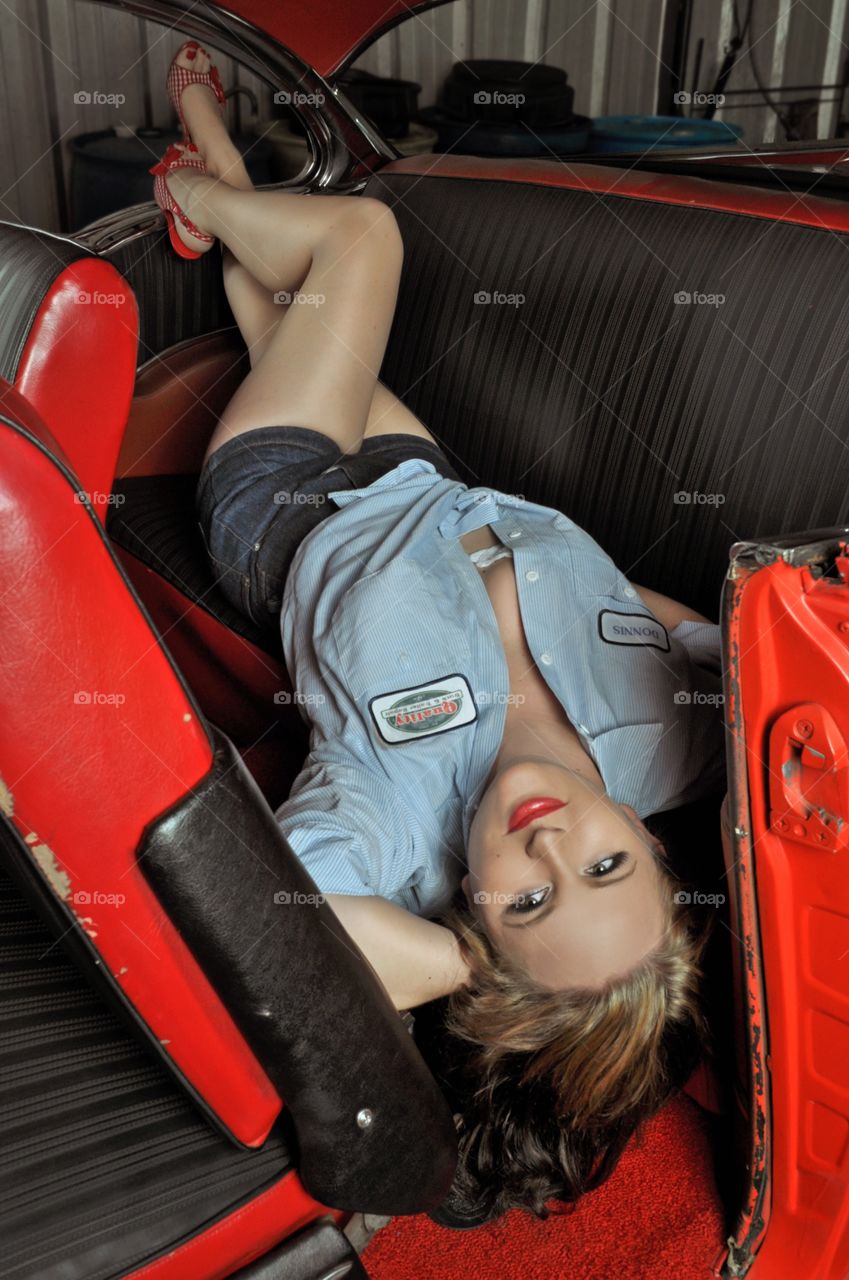 Woman posing on car