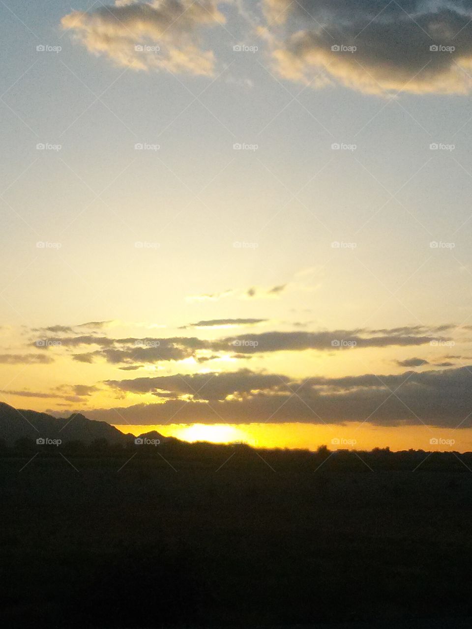 Sunset at Night in the Arizona Sky , Bright SunSet with a Mountainous Silleutte , has me take a Moment to See the Glorious Wonderful Evening Beauty .