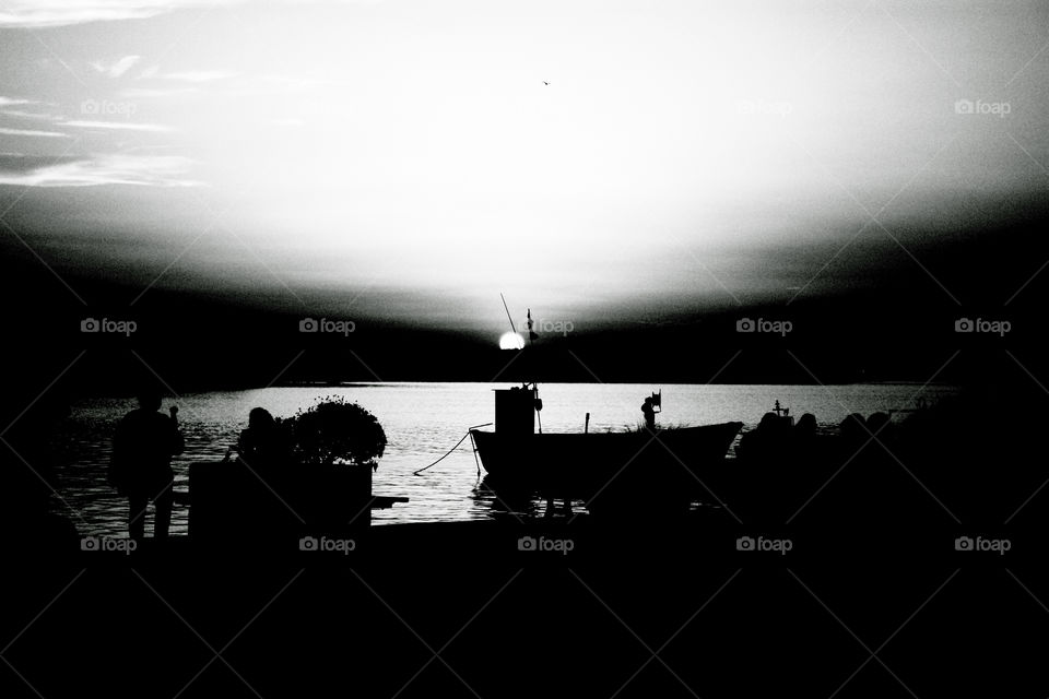Silhouette of boats at sunset. B/w rendering