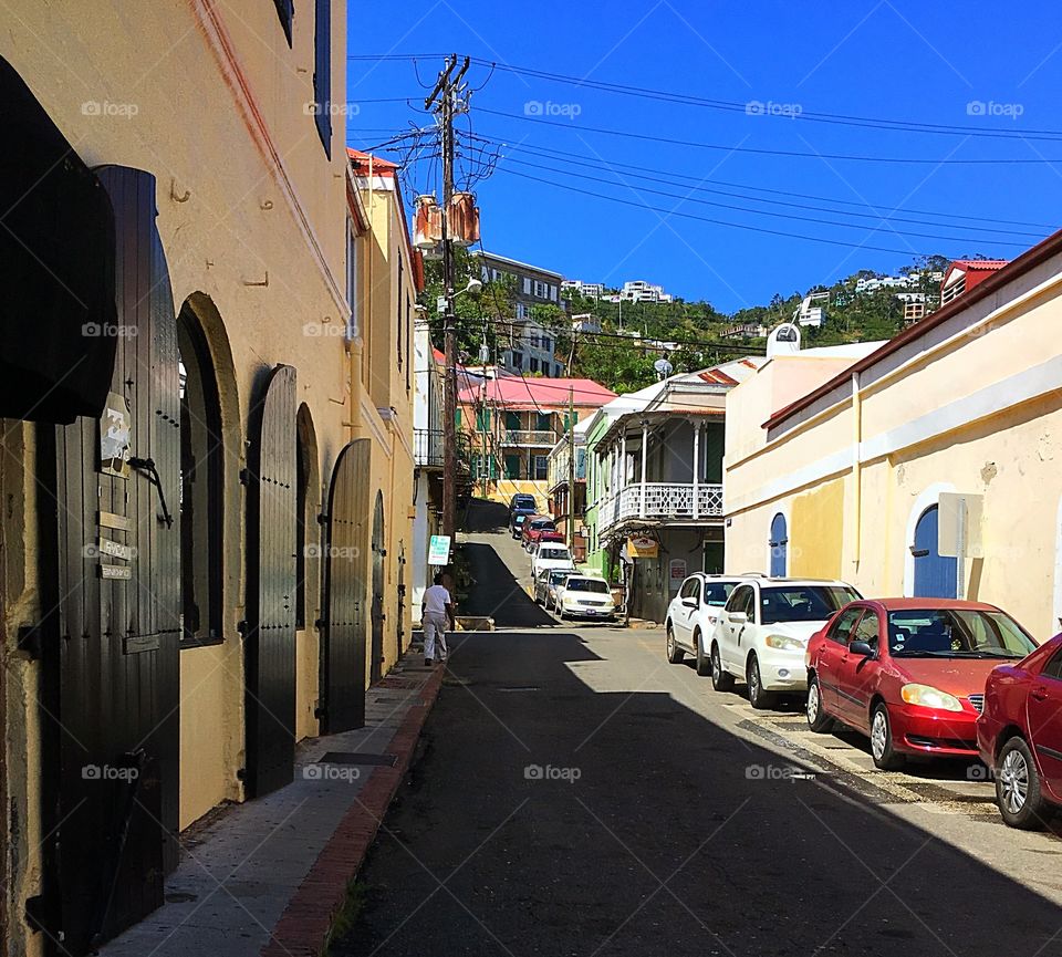 Looking up a street in St. Thomas.  Lights and shadows, blue sky and warm air...