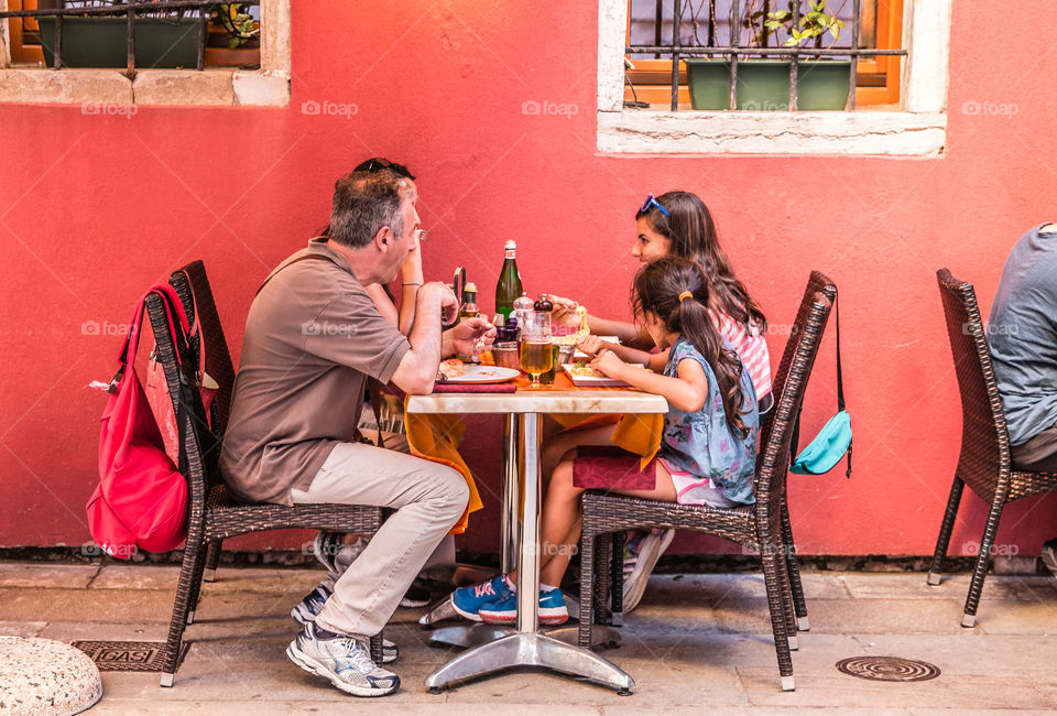 Family Enjoying Lunch At An Outdoor Restaurant
