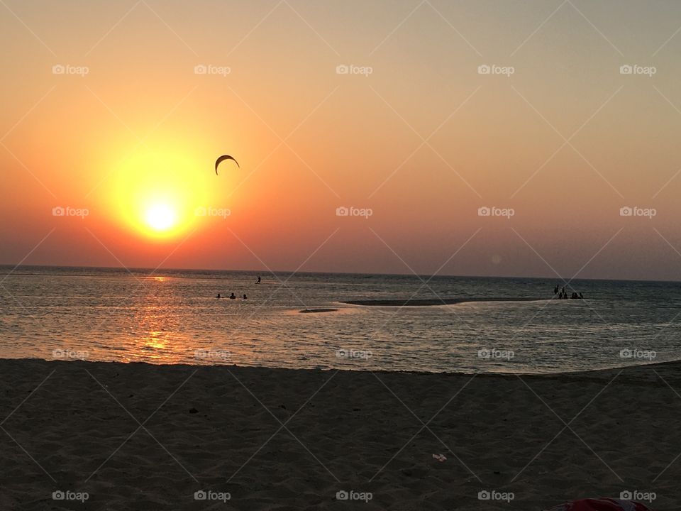 Kite is flying over the sun