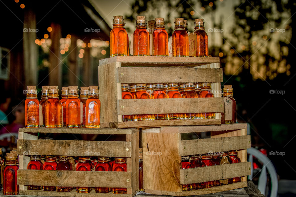 Stacked Crates of Honey Bottles