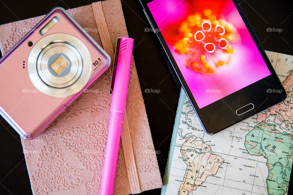 My daily routine, plan, write ideas, journal,  take photos and enjoy life day by day! Image of pink notebook pen world map camera and smartphone with pink macro image of flower