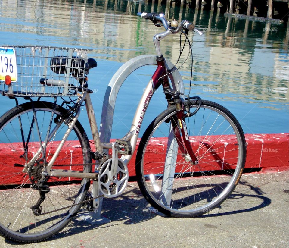 Bicycle parked by the water