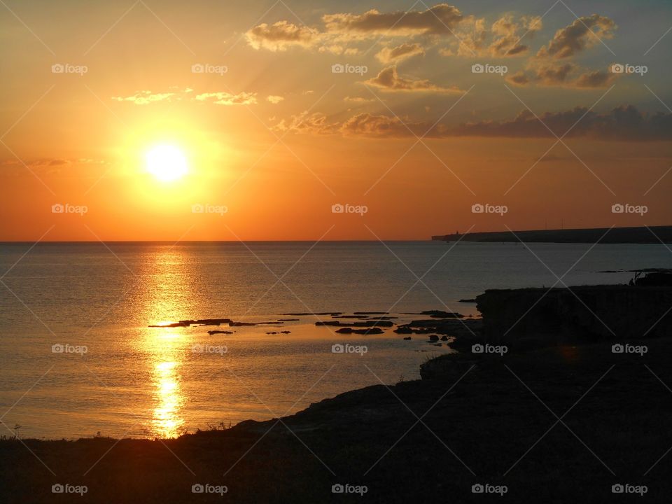 Sunlight over sea during sunset