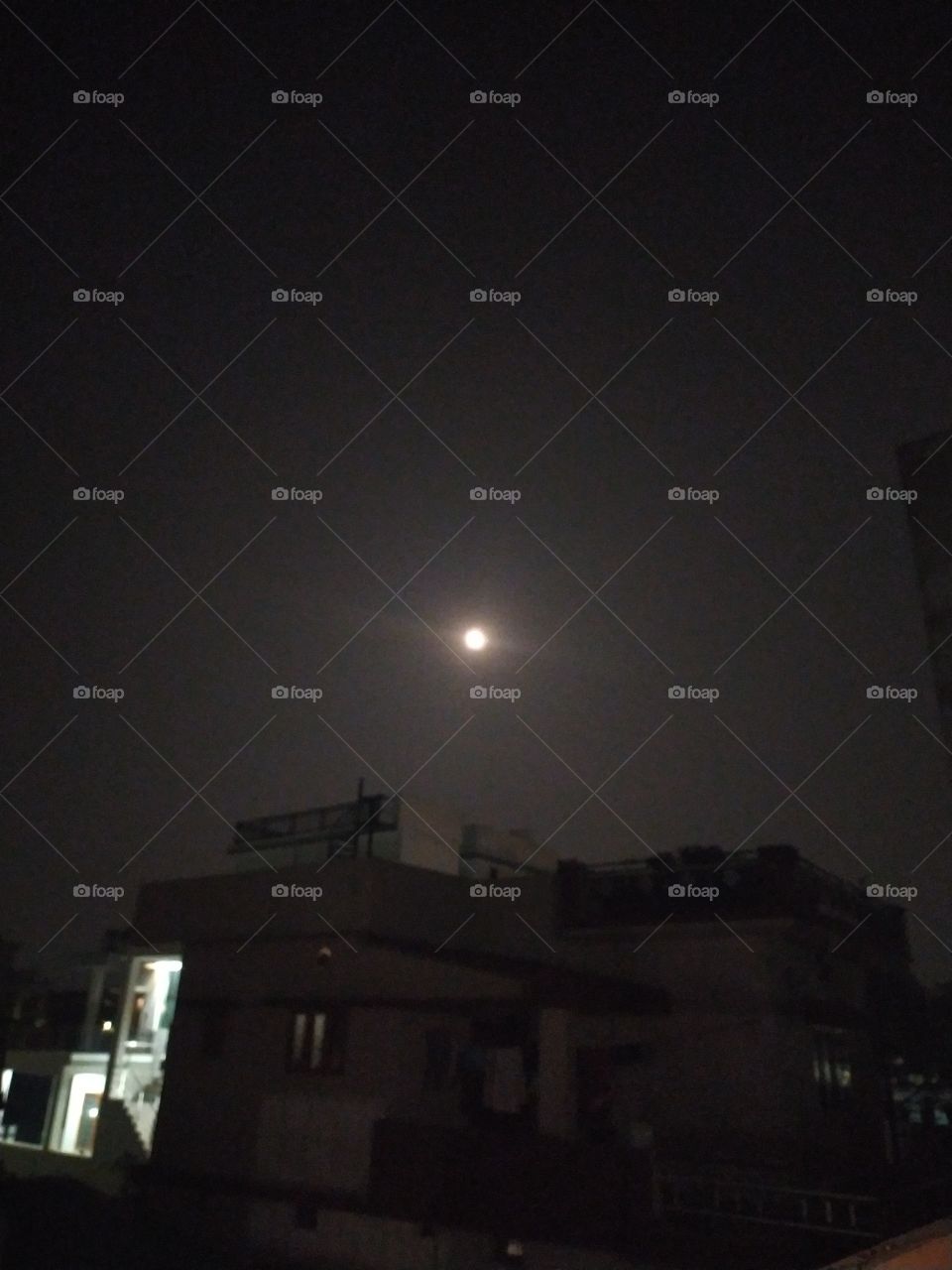 Full moon spreading its brightness over the pandemic-hit town