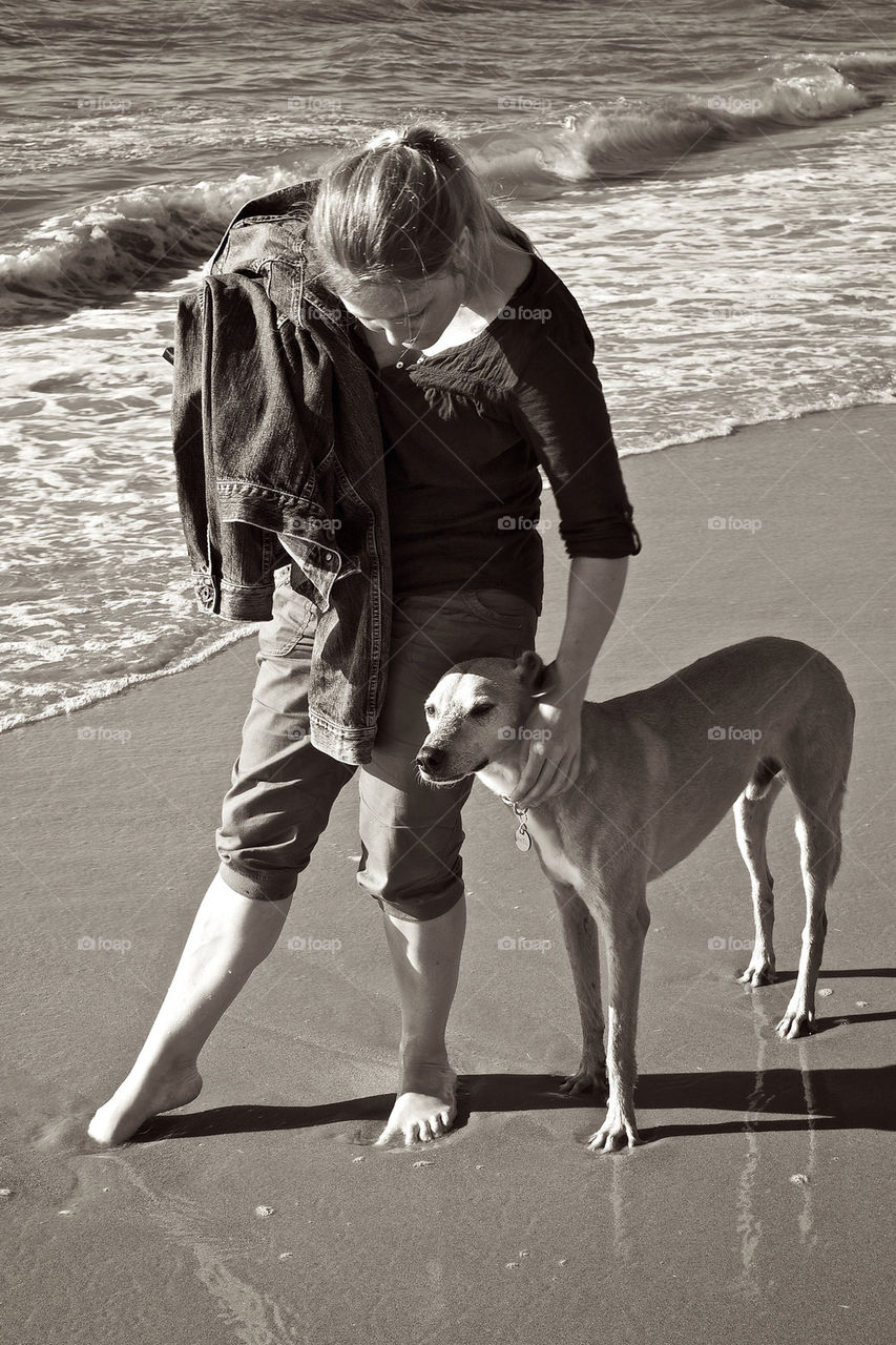 Girl and her dog on the beach