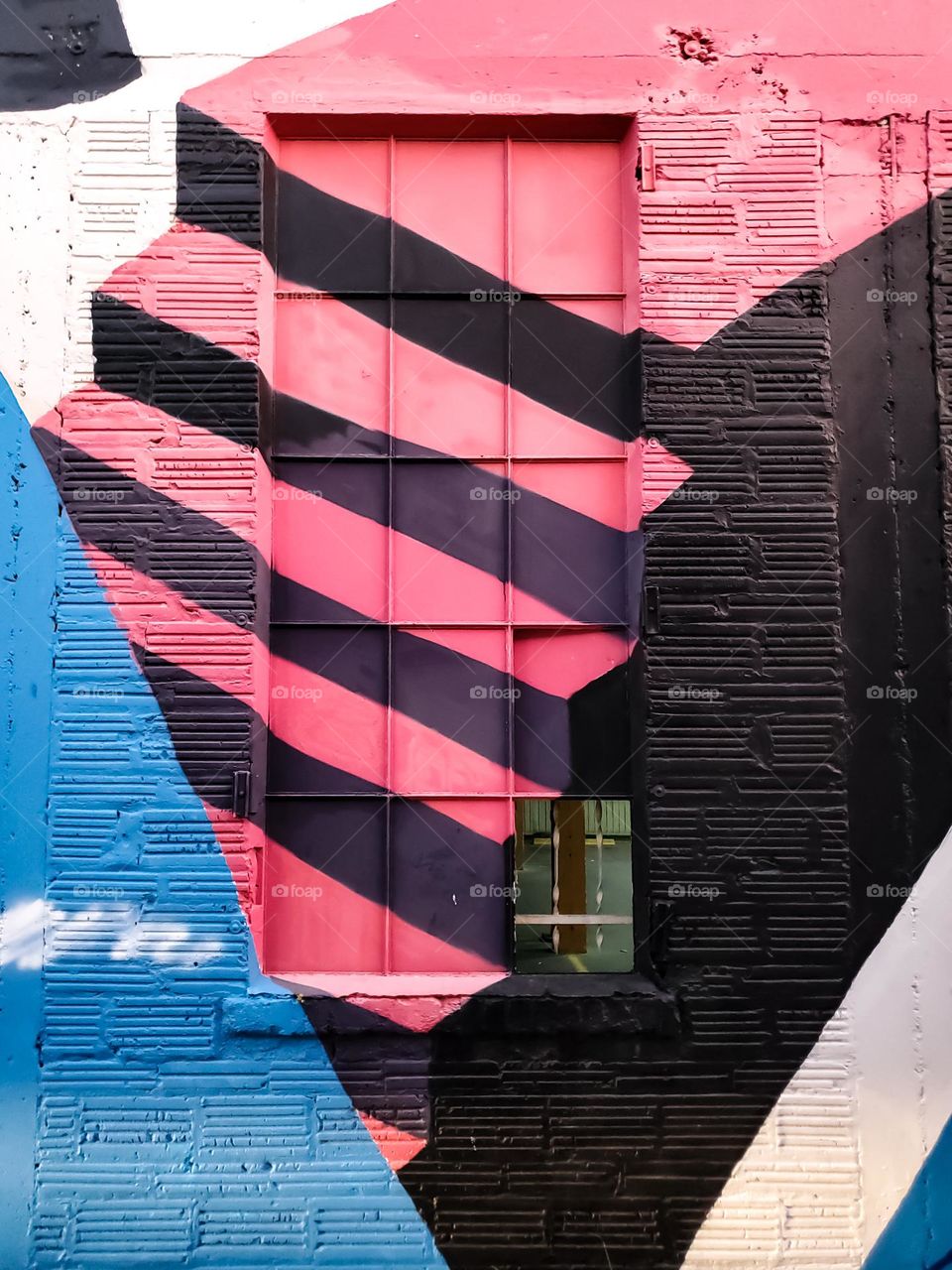 Pink stairs spotted painted on a window and wall.