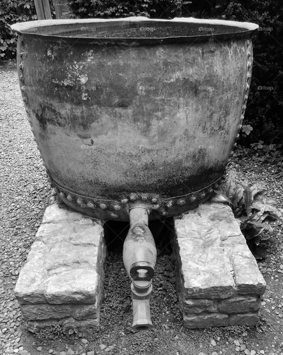 Antique water butt in Sir Charles Wade’s garden at Snowshill Manor in the Cotswolds 