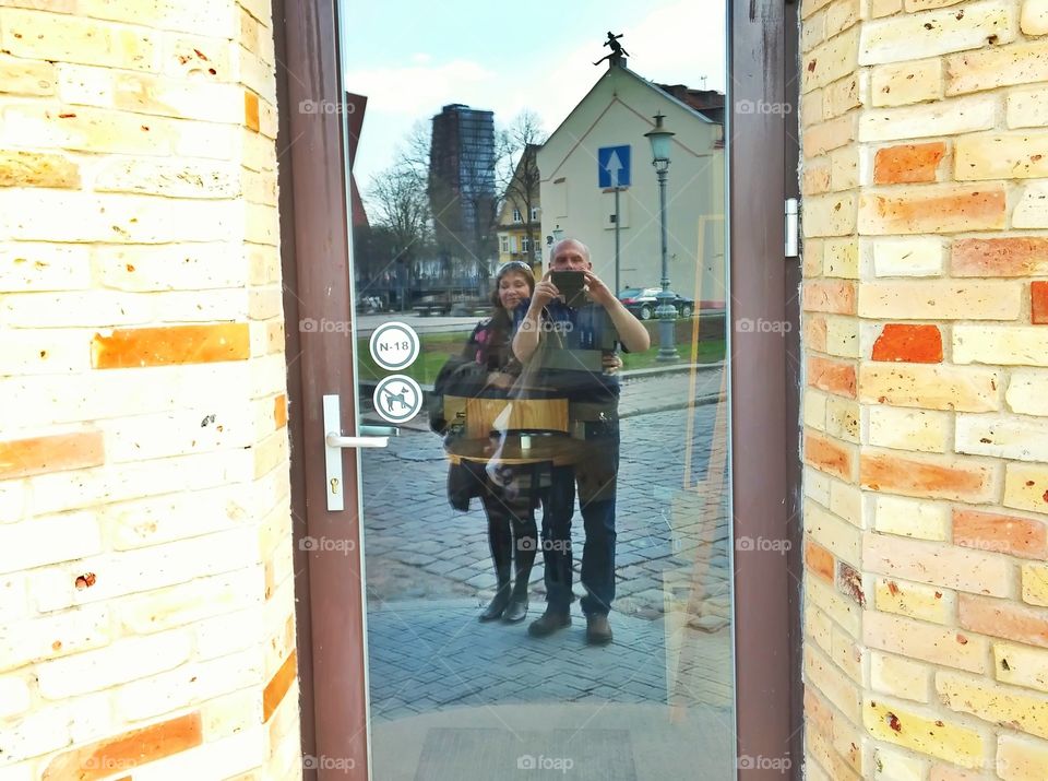 Reflection of couple in door glass