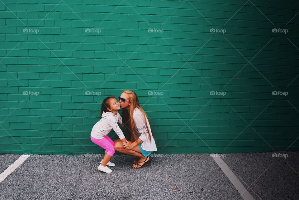 Mother kissing her daughter