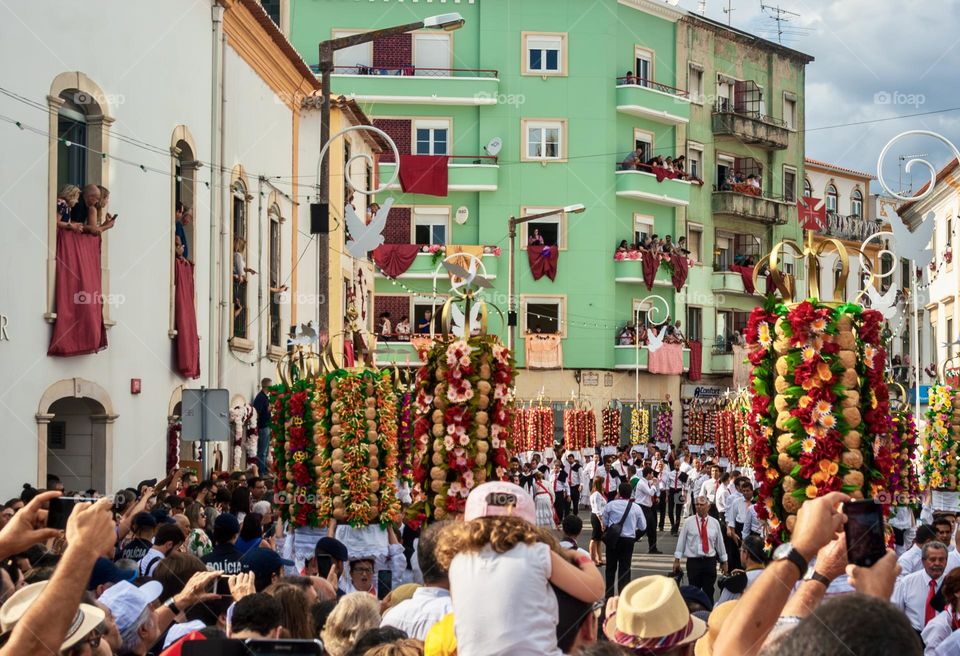 A crowd of people watch the Cortejo dos Tabuleiros for Festa Dos Tabuleiros in Tomar, Portugal 2023. 