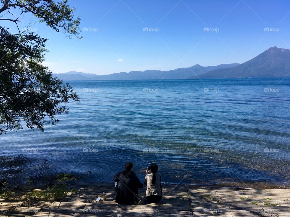 Two people relaxing by Lake Shikotsu 