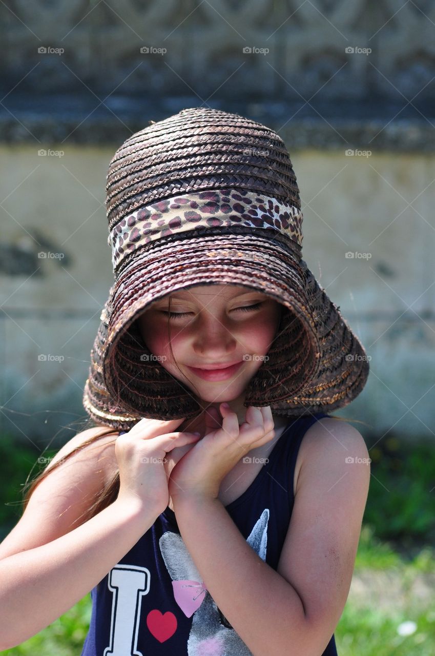 Beautiful little girl with straw hat