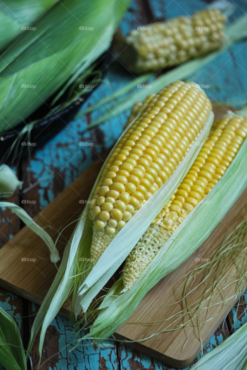 Fresh corn on a wooden board