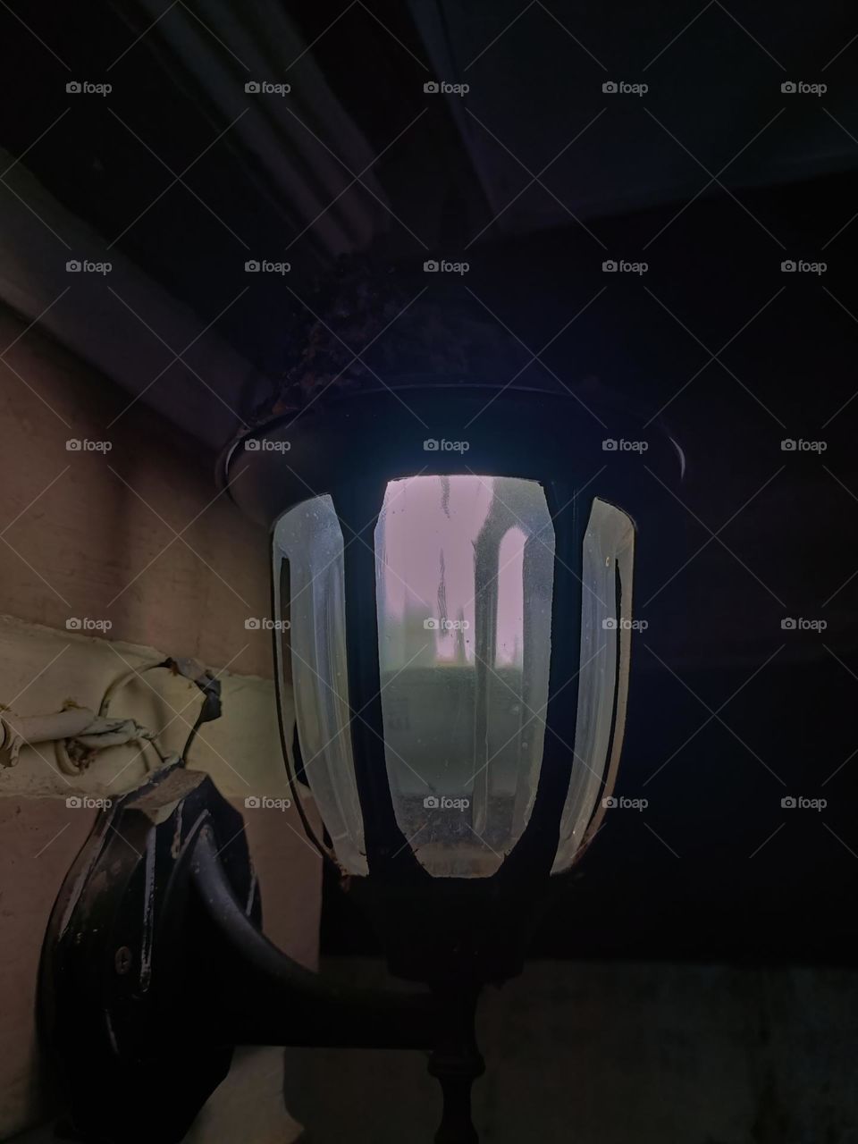 Warm white light lantern illuminating the front porch at night