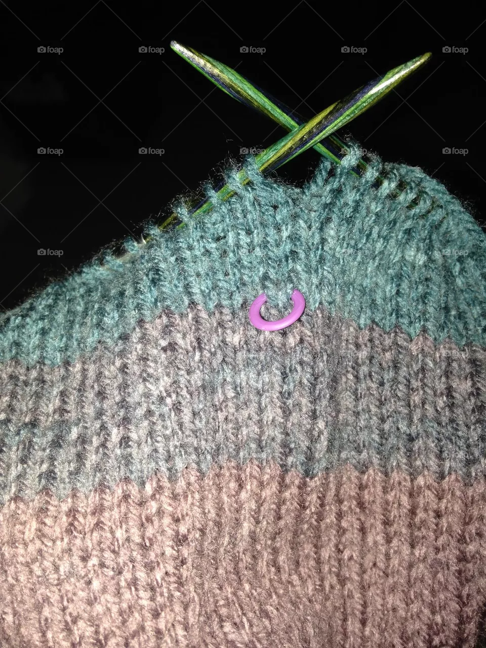 Oops-stitch marker captured in striped knitting
