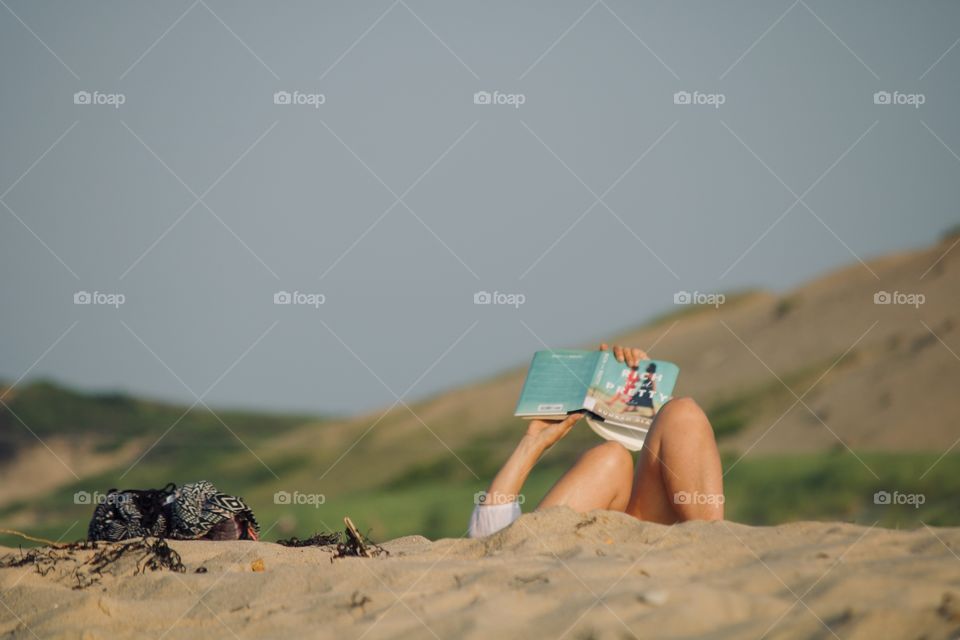 Reading a book on the beach 