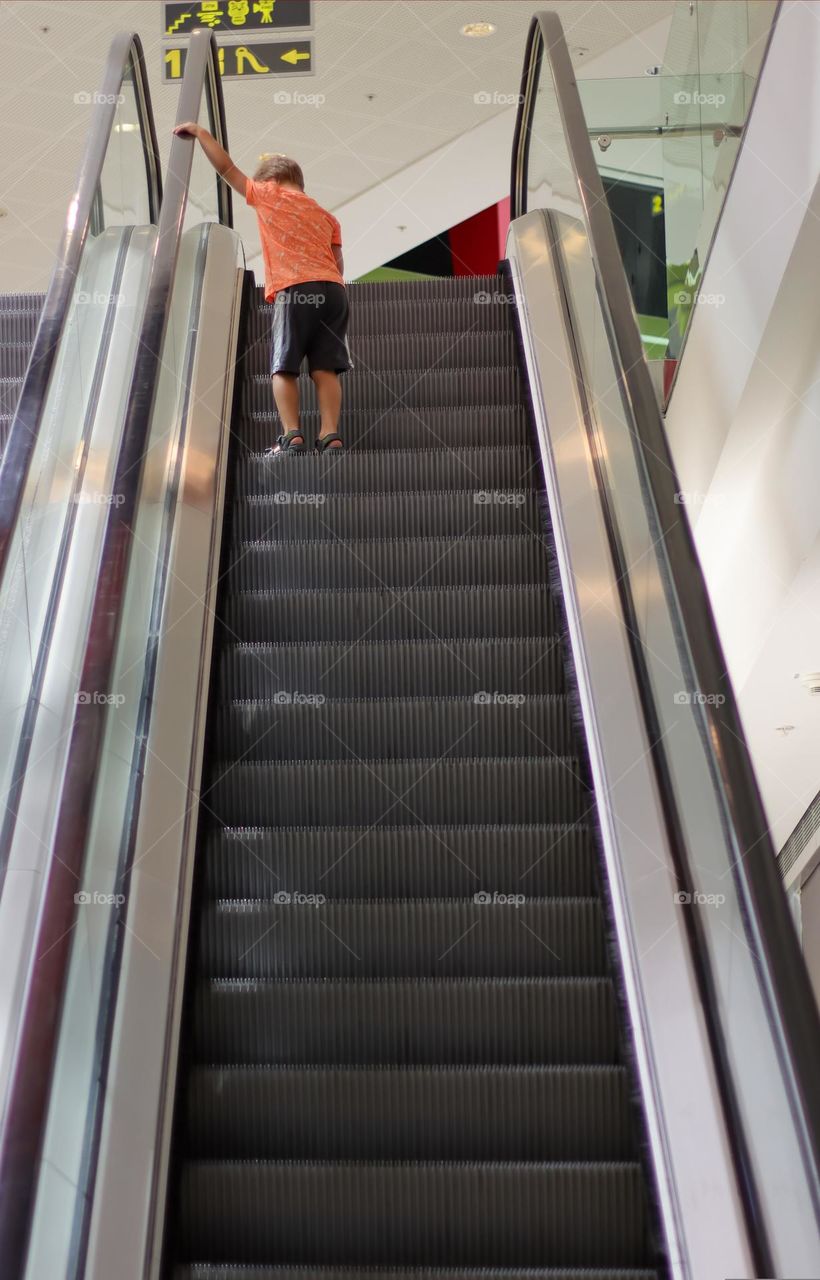 A boy on the escalator