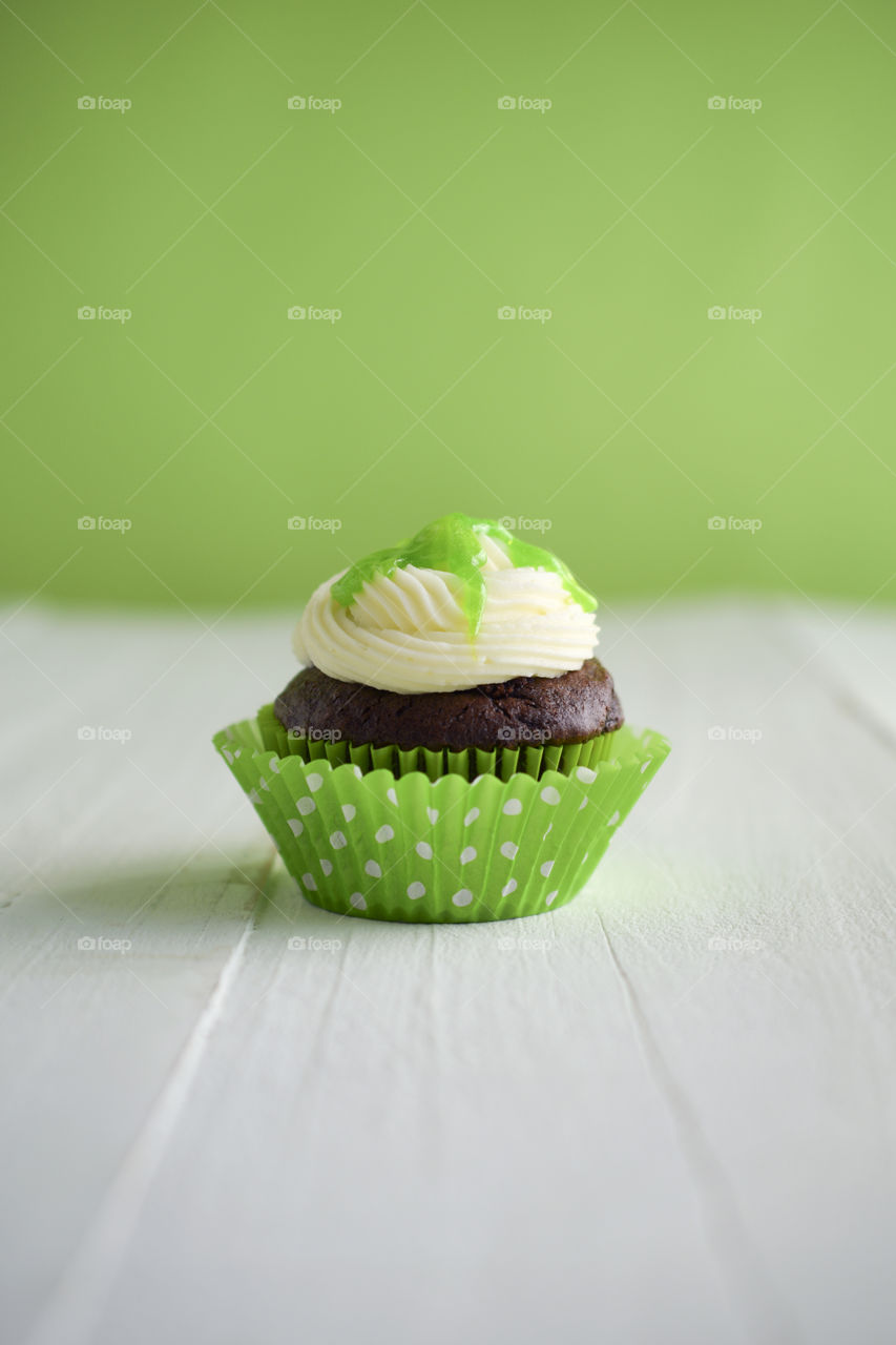 Chocolate Cupcake with a Green Background 