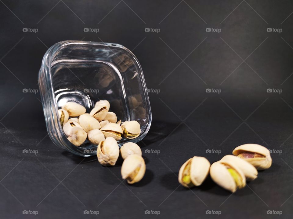 Pistachios on a table on a black background