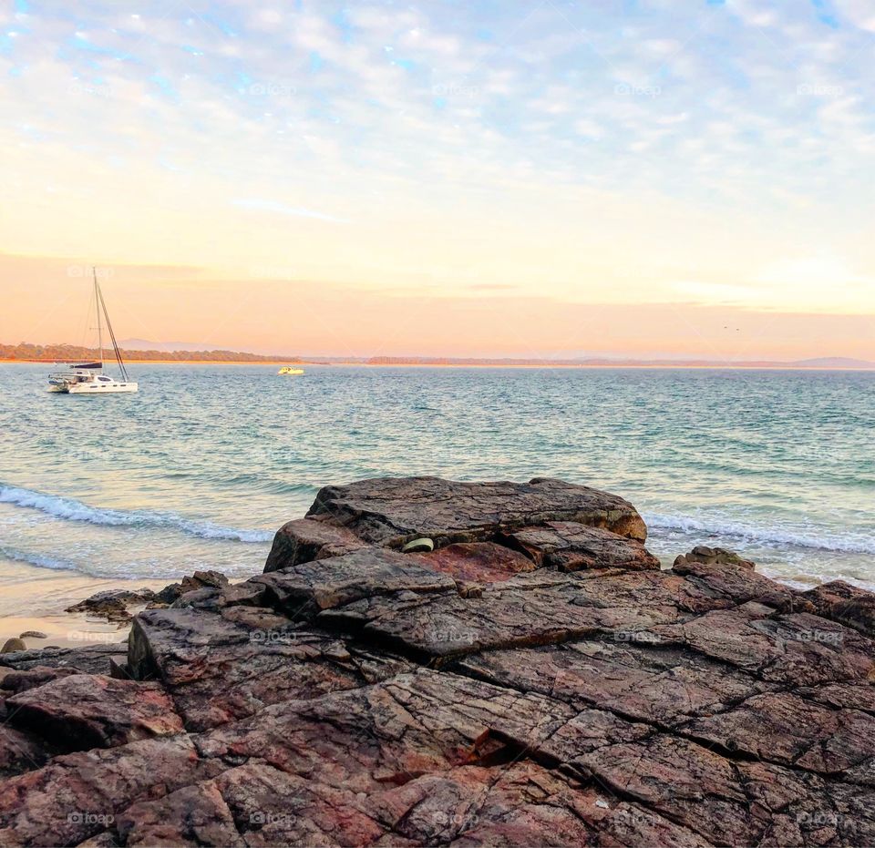 The rocks to the sea with a wonderful yacht 
