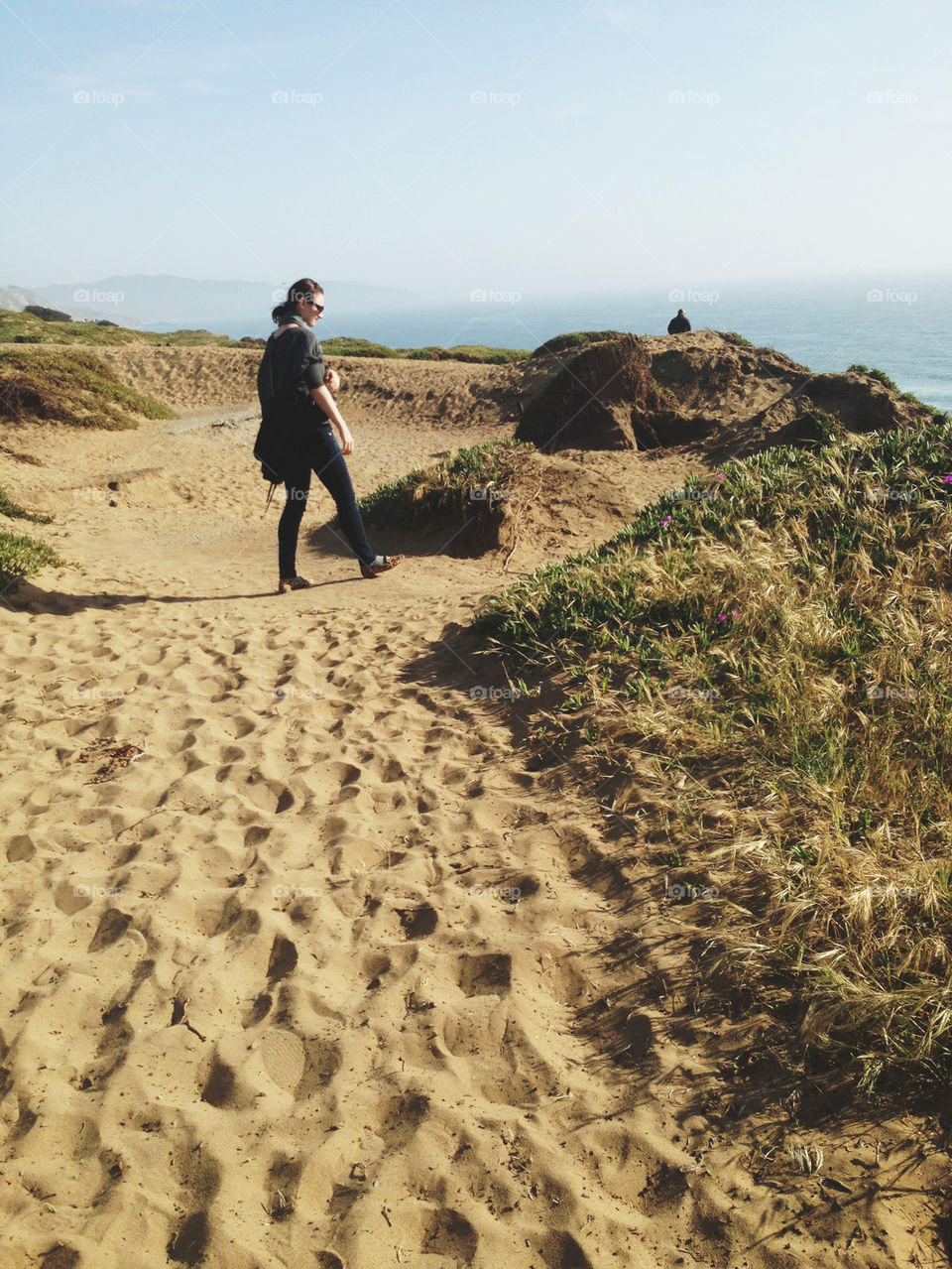 WOMAN WALKING ON SAND