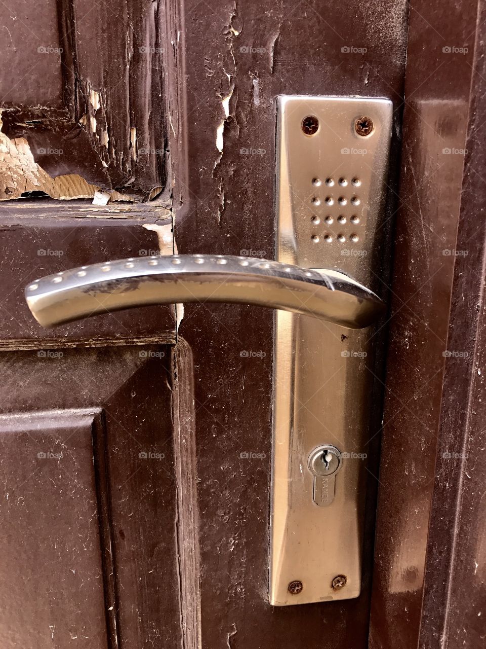 Brown door silver door handle flakey brown paint 