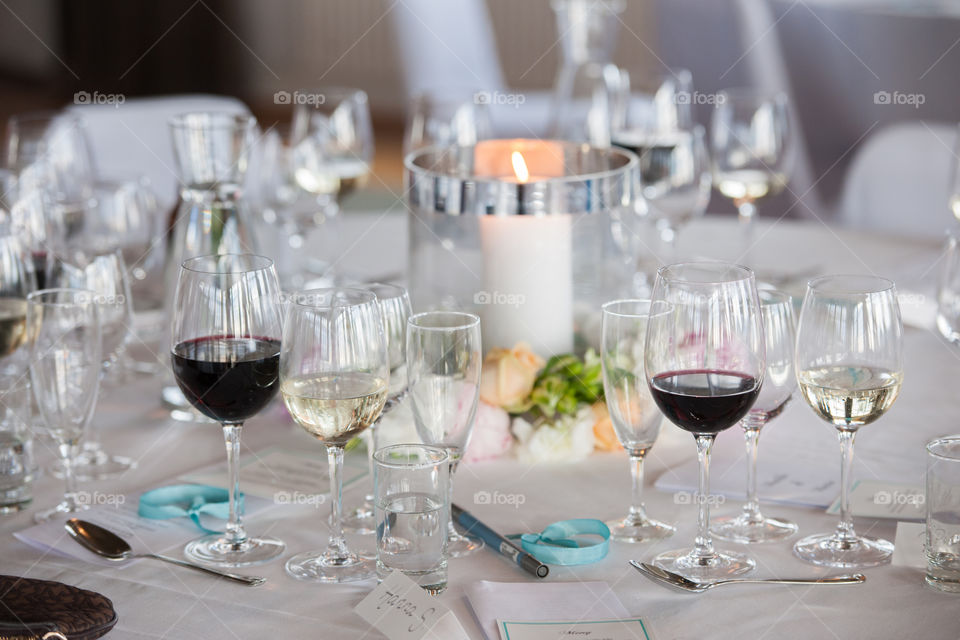 beer mugs and wine glasses on a dinner table at a party