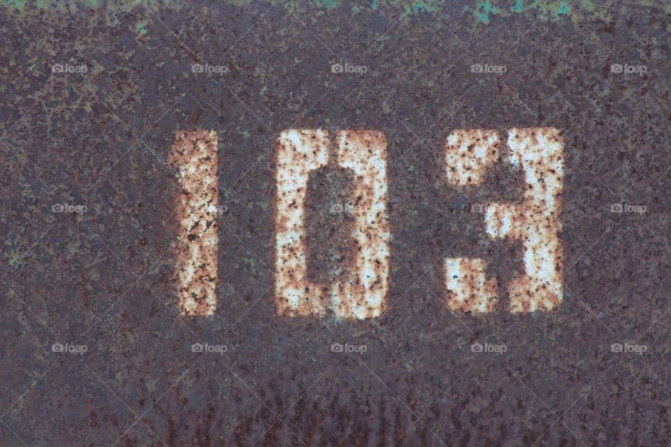 Stenciled numbers on rusty steel